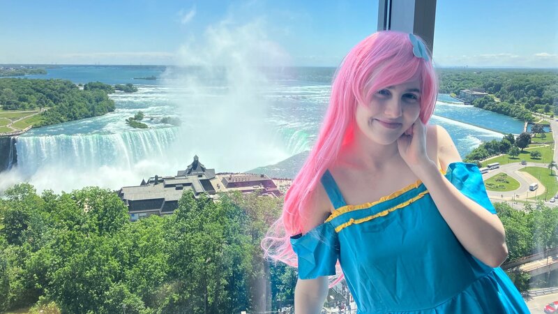 Size: 2048x1152 | Tagged: safe, artist:darknightprincess, artist:magicalmysticva, derpibooru import, fluttershy, human, clothes, cosplay, costume, dress, gala dress, hotel room, image, irl, irl human, jpeg, neighagra falls, photo, solo, vacation, window