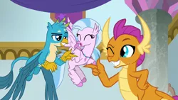 Size: 1280x720 | Tagged: safe, derpibooru import, screencap, gallus, silverstream, smolder, classical hippogriff, dragon, gryphon, hippogriff, season 9, she's all yak, spoiler:s09, ^^, cute, diastreamies, dragoness, eyes closed, female, finger gun, finger guns, flying, image, looking at each other, looking at someone, male, png, pointing at each other, smiling, trio