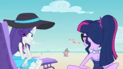 Size: 1920x1080 | Tagged: safe, derpibooru import, screencap, rarity, sci-twi, spike, spike the regular dog, twilight sparkle, dog, equestria girls, equestria girls series, forgotten friendship, beach, beach chair, bikini, breasts, clothes, drone, duo, duo female, female, hat, image, png, rarity's blue sarong, rarity's purple bikini, sarong, sci-twi swimsuit, selfie drone, sitting, sun hat, swimsuit