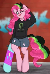 Size: 1846x2723 | Tagged: safe, artist:ponykittenboi, derpibooru import, pinkie pie, earth pony, semi-anthro, ;p, alternate hairstyle, arm behind head, bipedal, brick wall, clothes, cutie mark, denim, denim shorts, derpibooru exclusive, dyed mane, dyed tail, ear fluff, ear piercing, eyeshadow, graffiti, hoodie, image, logo, makeup, monster energy, one eye closed, piercing, png, punkie pie, shitposting, shorts, skateboard, solo, tail, tongue out, torn clothes, wink