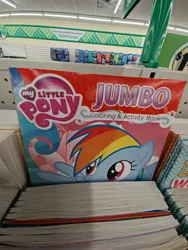 Size: 2448x3264 | Tagged: safe, derpibooru import, rainbow dash, pegasus, pony, coloring book, dollar tree, female, high res, image, irl, jpeg, mare, my little pony jumbo coloring book, my little pony logo, open mouth, open smile, photo, raised hoof, smiling, solo, spread wings, wings