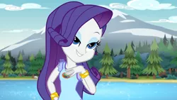 Size: 1920x1080 | Tagged: safe, derpibooru import, screencap, rarity, equestria girls, legend of everfree, eyebrows, eyeshadow, female, grin, hand on hip, image, lidded eyes, makeup, mountain, png, river, smiling, solo, tree, water