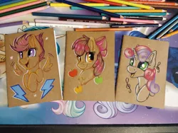 Size: 1152x864 | Tagged: safe, artist:julunis14, derpibooru import, apple bloom, scootaloo, sweetie belle, earth pony, pegasus, pony, unicorn, apple, bow, colored pencil drawing, cute, cutie mark crusaders, excited, food, image, jpeg, music notes, notebook, spread wings, traditional art, wings