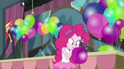 Size: 1000x563 | Tagged: safe, derpibooru import, screencap, pinkie pie, sunset shimmer, human, all the world's off stage, equestria girls, equestria girls series, all the world's off stage: pinkie pie, balloon, blowing up balloons, clothes, female, geode of sugar bombs, image, magical geodes, png, rah rah skirt, skirt, stage