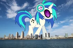 Size: 2100x1400 | Tagged: safe, artist:dashiesparkle, artist:jaredking779, derpibooru import, vinyl scratch, pony, unicorn, california, female, giant pony, giant unicorn, giant vinyl scratch/giant dj-pon 3, giantess, glasses, headphones, highrise ponies, image, irl, macro, mare, mega giant, photo, png, ponies in real life, san diego