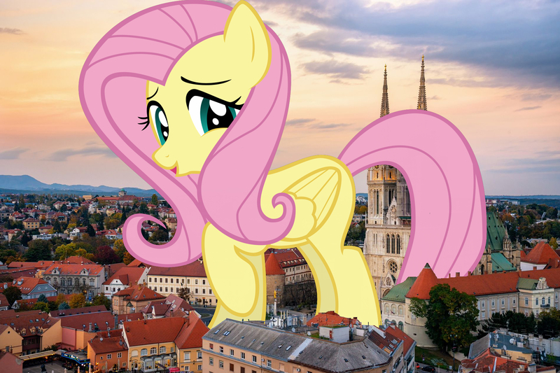 Size: 1900x1267 | Tagged: safe, artist:gratlofatic, artist:jaredking779, derpibooru import, fluttershy, pegasus, pony, croatia, female, giant pegasus, giant pony, giantess, giantshy, highrise ponies, image, irl, jpeg, looking at you, macro, mare, mega giant, photo, ponies in real life, raised hoof, solo, zagreb