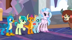 Size: 1600x898 | Tagged: safe, derpibooru import, screencap, gallus, ocellus, sandbar, silverstream, smolder, yona, changedling, changeling, classical hippogriff, dragon, earth pony, gryphon, hippogriff, pony, yak, uprooted, bow, cloven hooves, colored hooves, dragoness, female, hair bow, image, jewelry, male, monkey swings, necklace, png, raised hoof, school of friendship, student six