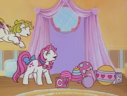 Size: 960x720 | Tagged: safe, derpibooru import, screencap, baby moondancer, baby surprise, alicorn, pony, unicorn, escape from catrina, my little pony 'n friends, animation error, baby, baby pony, ball, blocks, bow, duo, female, filly, foal, g1, image, jewelry, necklace, nursery, png, spot the alicorn, spread wings, tail, tail bow, wings
