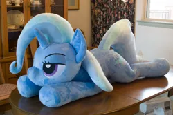 Size: 5184x3456 | Tagged: safe, artist:azgchip, derpibooru import, trixie, pony, unicorn, bedroom eyes, female, image, irl, life size, lying down, mare, photo, plushie, png, prone, solo, sploot, table