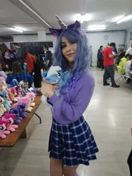 Size: 1622x2160 | Tagged: safe, artist:hysteriana, derpibooru import, izzy moonbow, minuette, human, pony, g5, blue hair, choker, clothes, cosplay, costume, cute, festival, hug, image, irl, irl human, legs, photo, plushie, png, skirt, toy