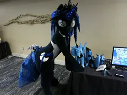 Size: 1758x1318 | Tagged: safe, artist:kolshica, derpibooru import, princess luna, alicorn, anthro, pony, bells, butt, clothes, crown, cutie mark, fursuit, glow, glowing horn, hooves on the table, horn, image, irl, jewelry, jpeg, leaning forward, looking at you, photo, plushie, ponysuit, regalia, solo, swimsuit, tail