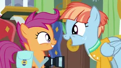 Size: 1280x720 | Tagged: safe, derpibooru import, screencap, scootaloo, windy whistles, pegasus, pony, parental glideance, bag, camera, cute, cutealoo, female, filly, foal, freckles, grin, image, looking at each other, looking at someone, mare, open mouth, open smile, png, saddle bag, smiling, smiling at each other, windybetes