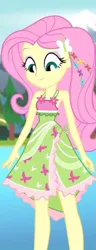 Size: 208x544 | Tagged: safe, derpibooru import, screencap, fluttershy, equestria girls, equestria girls series, legend of everfree, armpits, background, bare shoulders, boho, camp fashion show outfit, clothes, dress, eyeshadow, grin, hairpin, image, jpeg, looking at self, makeup, mountain, pond, sleeveless, smiling, tree, water