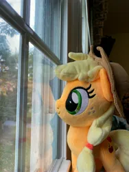 Size: 3024x4032 | Tagged: safe, derpibooru import, applejack, contemplating, image, irl, jpeg, merchandise, photo, plushie, reflection, symbiote studios, window