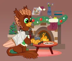 Size: 1600x1350 | Tagged: safe, artist:pink-pone, derpibooru import, oc, oc:pavlos, unofficial characters only, gryphon, broken bone, broken wing, cast, chocolate, christmas, christmas stocking, christmas tree, clothes, colored wings, cookie, eared griffon, fireplace, folded wings, food, griffon oc, happy, holiday, hot chocolate, image, injured, male, photo, png, simple background, sitting, sling, smiling, solo, sweater, tree, wing fluff, wings