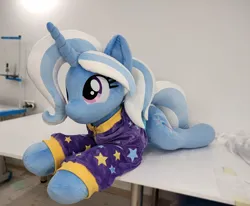 Size: 4208x3472 | Tagged: safe, artist:lanacraft, derpibooru import, trixie, pony, unicorn, alternate hairstyle, babysitter trixie, clothes, g4, hoodie, image, irl, jpeg, lying down, photo, plushie, prone, smiling, sploot