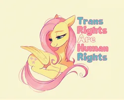 Size: 4096x3290 | Tagged: safe, artist:imalou, derpibooru import, fluttershy, pegasus, pony, cute, female, image, jpeg, lying down, mare, mouthpiece, ponyloaf, pride, pride flag, prone, shyabetes, sitting, text, transgender pride flag, wings