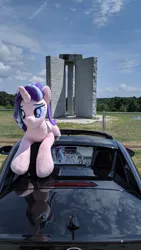 Size: 2160x3840 | Tagged: safe, derpibooru import, starlight glimmer, pony, unicorn, car, chain link fence, cloud, elbert county, female, fence, georgia (state), granite, grass, image, irl, jpeg, lidded eyes, lying down, mare, monument, photo, plushie, prone, solo, tree