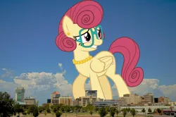 Size: 2048x1362 | Tagged: safe, artist:outlawquadrant, derpibooru import, edit, editor:jaredking779, posey shy, pegasus, pony, ear piercing, earring, female, folded wings, giant pegasus, giant pony, giantess, glasses, grin, highrise ponies, image, irl, jewelry, jpeg, kansas, macro, mare, mega giant, necklace, nervous, nervous grin, pearl necklace, photo, piercing, ponies in real life, smiling, solo, wichita, wings