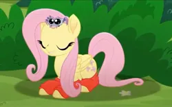 Size: 2160x1344 | Tagged: safe, derpibooru import, screencap, fluttershy, pegasus, pony, spider, rainbow roadtrip, big eyes, bush, clothes, cropped, cute, eyes closed, female, flower, folded wings, happy, hope hollow, image, jpeg, laid down, mare, socks, wings