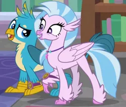 Size: 1855x1580 | Tagged: safe, derpibooru import, screencap, gallus, silverstream, gryphon, hippogriff, a matter of principals, bookshelf, cropped, duo, duo male and female, excited, female, happy, image, jpeg, male, rug, school, smug