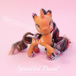 Size: 2048x2048 | Tagged: safe, artist:beccaintoyland, derpibooru import, oc, oc:sprinkled donut, pony, unicorn, my little pony: pony life, body markings, brown coat, brown hair, brown mane, chocolate, colored hooves, curly mane, customized toy, donut, food, g4, image, irl, multicolored mane, orange eyes, photo, pink mane, png, repaint, sprinkles, toy
