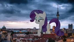 Size: 900x506 | Tagged: safe, artist:chapto, derpibooru import, rarity, pony, unicorn, berlin, female, giant ponies in real life, giant pony, giantess, highrise ponies, image, irl, looking down, macro, macro/micro, mare, micro, photo, png, ponies in real life, raised hoof, smiling, walking