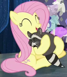 Size: 446x514 | Tagged: safe, derpibooru import, screencap, fluttershy, softpad, pegasus, pony, raccoon, fake it 'til you make it, season 8, spoiler:s08, cropped, cute, eyes closed, female, happy, hnnng, hug, image, mare, png, shyabetes