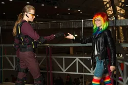 Size: 1280x853 | Tagged: safe, artist:helen the witch, artist:pegasus_fs, derpibooru import, rainbow dash, human, armor, clothes, cosplay, costume, glasses, image, irl, irl human, jacket, jpeg, leather, leather jacket, looking at each other, looking at someone, photo, rainbow socks, reaching, rubronycon, shadowbolts, shadowbolts costume, smiling, socks, striped socks