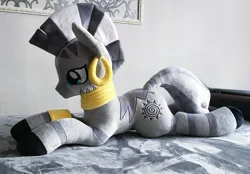 Size: 2048x1428 | Tagged: safe, artist:mdcraft10, derpibooru import, zecora, pony, zebra, ear piercing, earring, female, image, indoors, irl, jewelry, jpeg, lying down, mare, photo, piercing, plushie, prone, solo