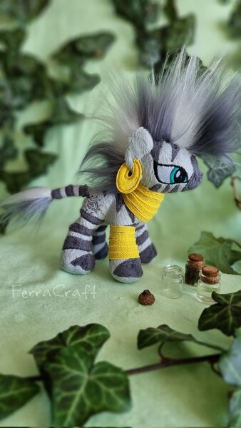 Size: 1153x2048 | Tagged: safe, artist:ferracraft, derpibooru import, zecora, pony, zebra, ear piercing, earring, female, image, irl, ivy (plant), jewelry, jpeg, leaf, mare, neck rings, photo, piercing, plushie, solo