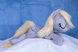 Size: 1511x1010 | Tagged: safe, artist:buttercupbabyppg, derpibooru import, derpy hooves, pegasus, pony, eyes closed, female, folded wings, happy, image, irl, jpeg, lying down, mare, photo, plushie, prone, sleeping, wings