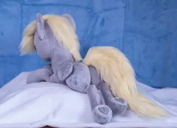 Size: 1397x1007 | Tagged: safe, artist:buttercupbabyppg, derpibooru import, derpy hooves, pegasus, pony, eyes closed, female, folded wings, happy, image, irl, jpeg, lying down, mare, photo, plushie, prone, sleeping, wings