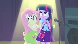 Size: 3072x1727 | Tagged: safe, derpibooru import, screencap, fluttershy, twilight sparkle, human, equestria girls, rainbow rocks, bare shoulders, clothes, cute, cutie mark, cutie mark on clothes, duo, duo female, female, frown, hairpin, image, jpeg, microphone, microphone stand, musical instrument, shyabetes, sleeveless, tambourine