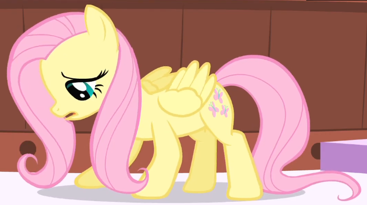 Size: 749x419 | Tagged: safe, derpibooru import, screencap, fluttershy, pegasus, pony, green isn't your color, season 1, cropped, crouching, cute, female, frown, image, looking down, mare, open mouth, partially open wings, png, ponyville spa, shyabetes, standing, wings, worried