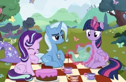 Size: 1016x660 | Tagged: artist needed, safe, derpibooru import, starlight glimmer, trixie, twilight sparkle, twilight sparkle (alicorn), alicorn, butterfly, insect, pony, unicorn, cake, cup, fence, food, image, jpeg, nature, picnic blanket, sitting, teacup, teapot, tree