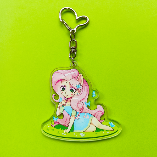 Size: 3389x3389 | Tagged: safe, artist:ikstina, derpibooru import, fluttershy, butterfly, human, insect, equestria girls, acrylic plastic, blushing, chibi, clothes, cute, dress, ears, for sale, grass, grass field, green background, green eyes, image, irl, keychain, long hair, looking down, makeup, merchandise, on grass, photo, pink hair, png, pony ears, sale, simple background, solo, sticker
