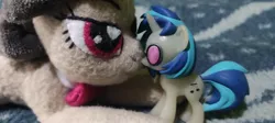 Size: 1156x520 | Tagged: safe, derpibooru import, octavia melody, vinyl scratch, earth pony, pony, unicorn, beanie (plushie), boop, cute, figurine, glow-in-the-dark, image, irl, jpeg, lying down, photo, plushie, size difference, toy