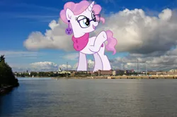 Size: 1600x1065 | Tagged: safe, artist:cirillaq, derpibooru import, edit, editor:jaredking779, raspberry latte, pony, unicorn, clothes, ear piercing, earring, female, finland, giant pony, giantess, glasses, helsinki, highrise ponies, image, irl, jewelry, jpeg, macro, mare, photo, piercing, ponies in real life, raised hoof, scarf, solo, story included