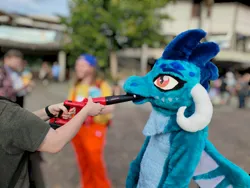Size: 2000x1500 | Tagged: safe, derpibooru import, princess ember, anthro, dragon, human, blurry background, clothes, convention, cosplay, costume, cute, female, furry, fursuit, galacon, gloves, image, indoors, irl, irl human, jpeg, leaf blower, orange eyes, photo, solo