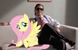 Size: 840x543 | Tagged: safe, derpibooru import, edit, fluttershy, human, pony, american psycho, couch, crossover, duo, female, image, jpeg, male, mare, smiling, sunglasses