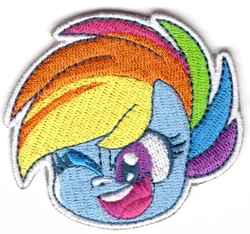 Size: 1050x984 | Tagged: safe, derpibooru import, official, rainbow dash, pegasus, my little pony: pony life, 2d, chibi, g4, image, jpeg, looking at you, merchandise, one eye closed, patch, photo, wink, winking at you