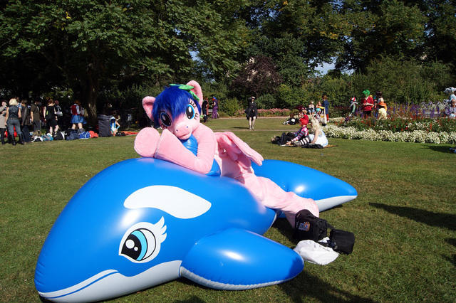 Size: 640x426 | Tagged: safe, artist:atalonthedeer, derpibooru import, firefly, human, whale, g1, 2012, connichi, fursuit, grass, grass field, image, inflatable, irl, irl human, jpeg, lying down, outdoors, photo, ponysuit, prone, solo focus