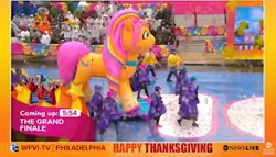 Size: 280x160 | Tagged: safe, derpibooru import, sunny starscout, earth pony, human, pony, g5, female, image, irl, irl human, jpeg, mane stripe sunny, mare, parade, parade balloon, philadelphia, photo, solo, solo female, text