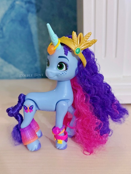 Size: 3201x4268 | Tagged: safe, derpibooru import, official, unicorn, g5, accessory, bracelet, brushable, concave belly, eyeshadow, freckles, friendship bracelet, horn, image, irl, jewelry, jpeg, looking back, makeup, merchandise, misty brightdawn, photo, slender, solo, standing, thin, tiara, toy