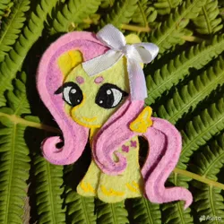 Size: 960x960 | Tagged: safe, artist:sofia metropolskaya, derpibooru import, fluttershy, pegasus, g4, chibi, craft, cute, felt, felting, handmade, image, jpeg, looking away, photo, ribbon, shyabetes, smiling, standing