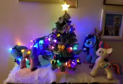 Size: 1792x1228 | Tagged: safe, artist:melodis, derpibooru import, izzy moonbow, zipp storm, pegasus, pony, unicorn, g5, animal costume, christmas, christmas decoration, christmas lights, christmas tree, clothes, costume, decoration, female, holiday, horn, image, irl, looking at each other, looking at someone, mare, misty brightdawn, photo, plushie, png, reindeer costume, tangled up, tree, trio, trio female