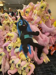 Size: 3000x4000 | Tagged: safe, derpibooru import, fluttershy, queen chrysalis, changeling, pegasus, pony, rabbit, g4, animal, clothes, convention, cute, everfree northwest, everfree northwest 2024, hay in a needle stack, image, irl, jewelry, jpeg, multeity, necklace, photo, plush pile, plushie, shyabetes, socks, striped socks