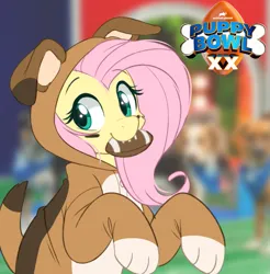 Size: 839x853 | Tagged: safe, artist:higgly-chan, derpibooru import, fluttershy, pegasus, pony, american football, beautiful, clothes, costume, cute, dog costume, female, halfbody, image, irl, looking at you, mouth hold, onesie, photo, png, pretty, puppy bowl, solo, sports