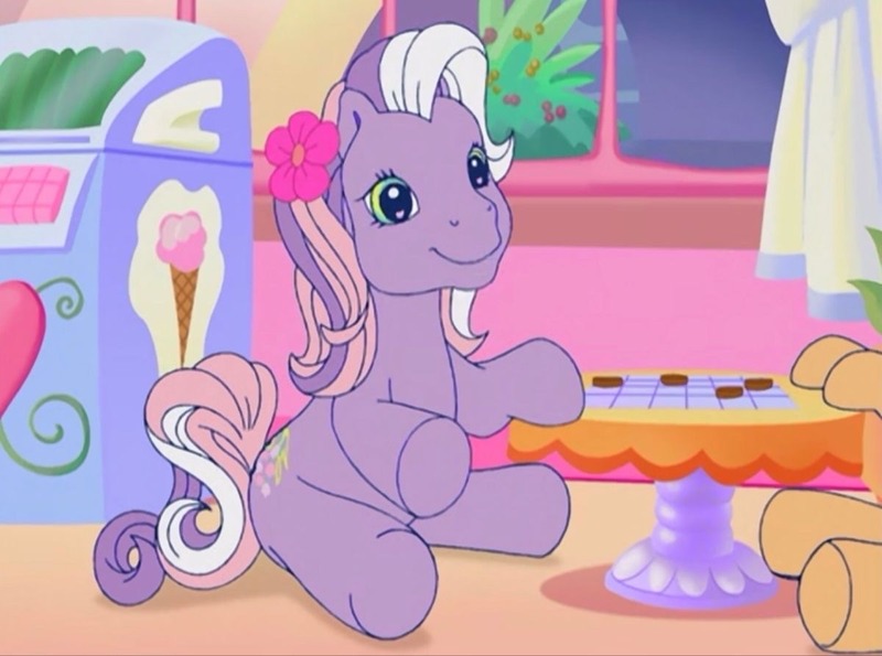 Size: 1200x892 | Tagged: safe, derpibooru import, screencap, wysteria, earth pony, pony, a charming birthday, g3, chocolate chip checkers, cotton candy cafe, cute, female, flower, flower in hair, g3betes, image, jpeg, mare, offscreen character, sitting, solo, table, wysteriadorable
